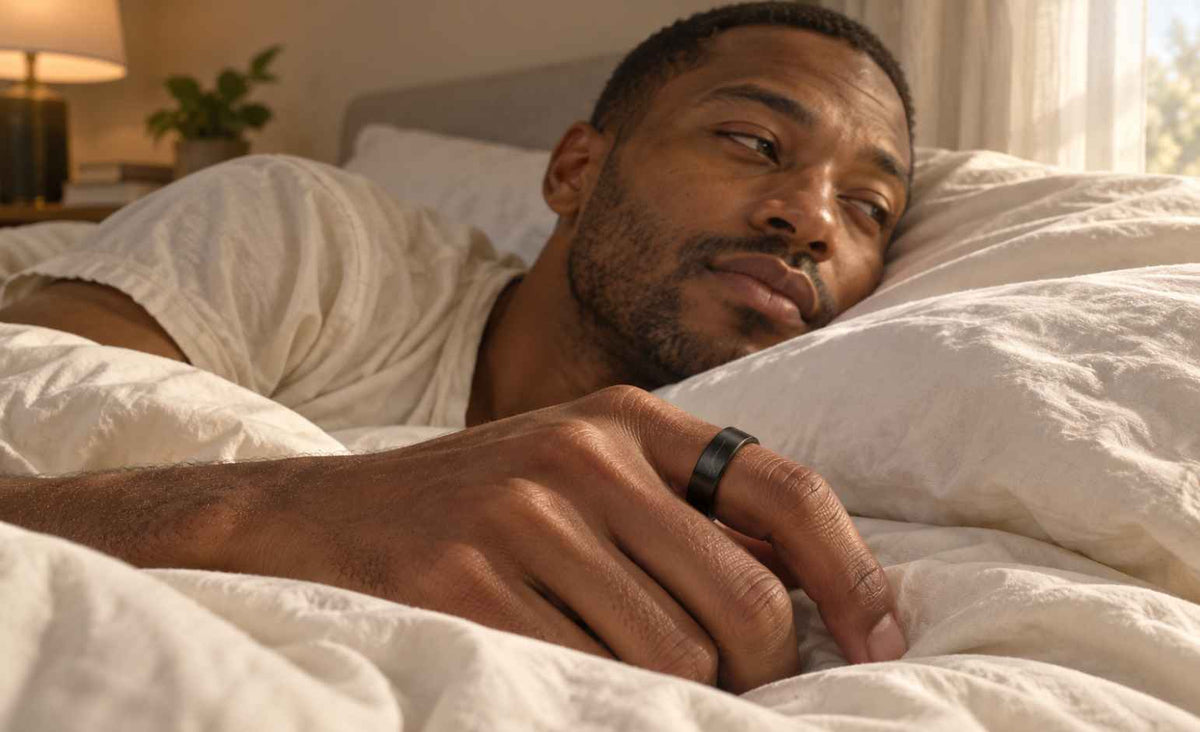 Man wearing a GemRing while resting in bed in the morning.